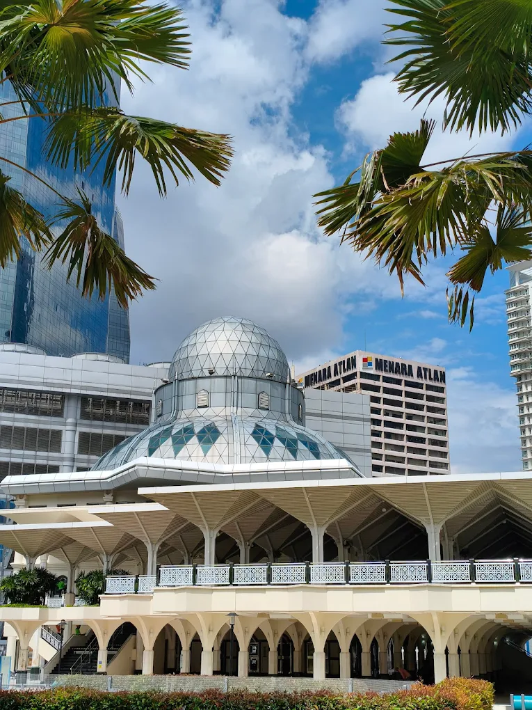 Masjid As-Syakirin, also known as the KLCC Mosque, sits at the foot of the Petronas Twin Towers and offers peaceful prayer spaces right in the heart of the city. With beautiful modern Islamic design, a welcoming atmosphere and separate facilities for men and women, it’s a favourite stop for Muslim travellers exploring KLCC Park and Suria Mall. The mosque is easy to reach by LRT and surrounded by halal dining options, making worship convenient while sightseeing in Kuala Lumpur.